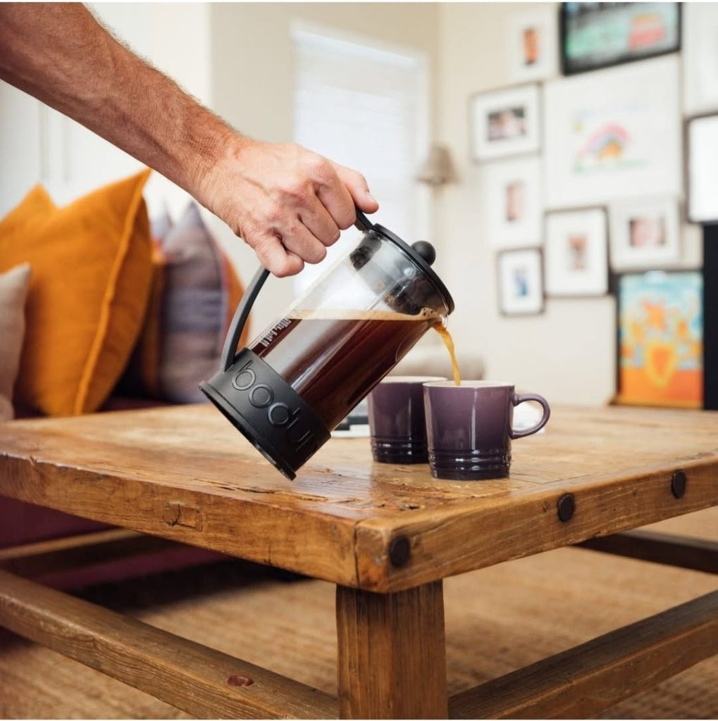 Coffee being poured from a brewer into a cup - The Curated Table
